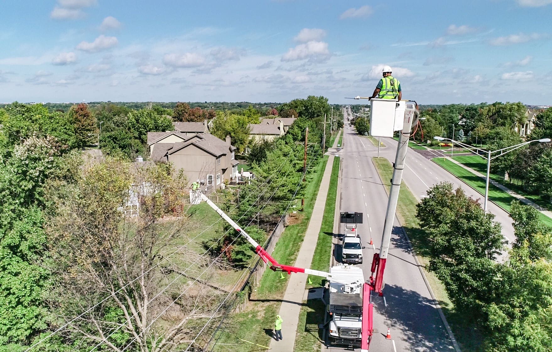 Tree trimmers in buckets wearing PAL safety lanyards