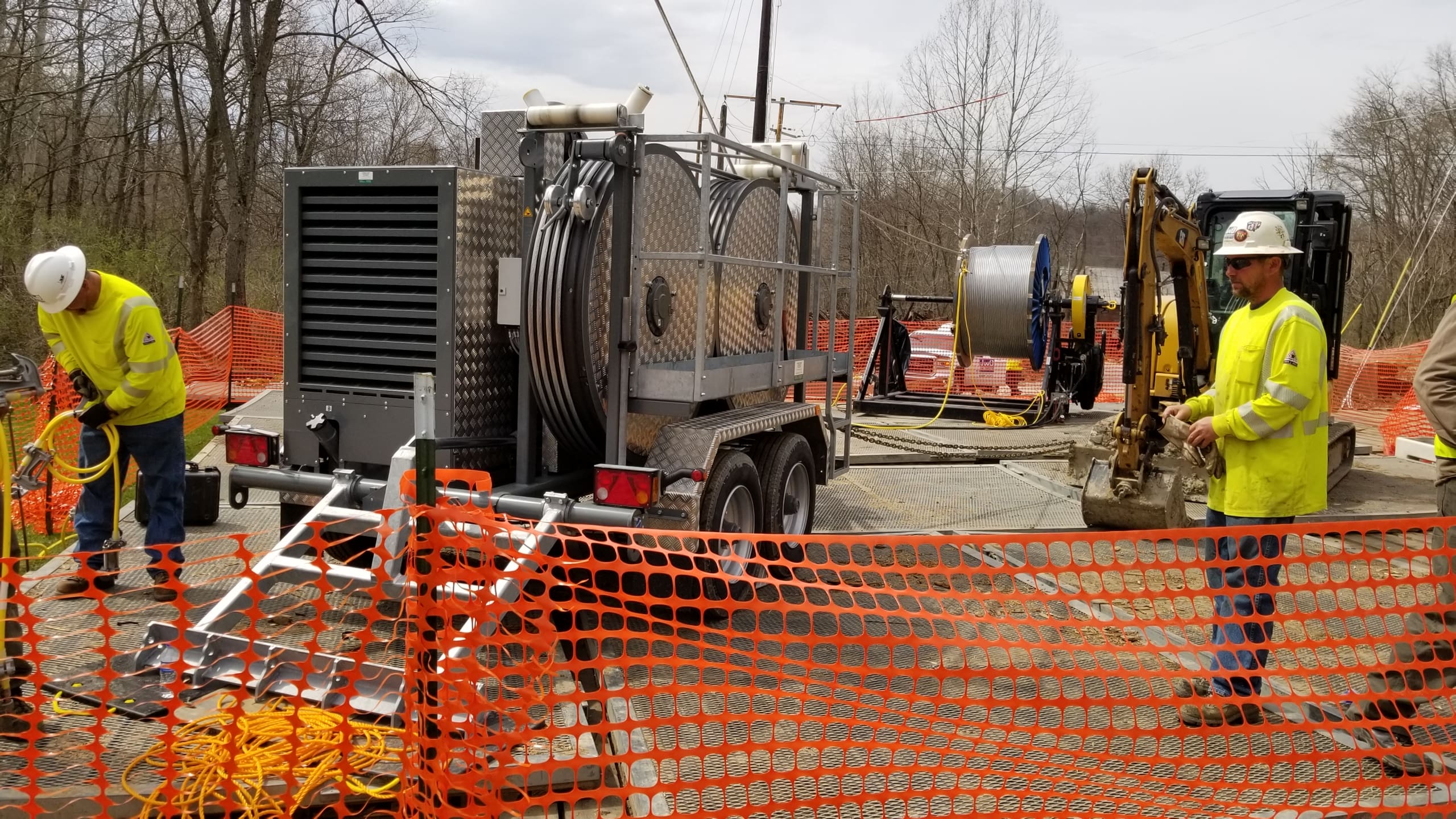 workers on a job site handling stringing equipment