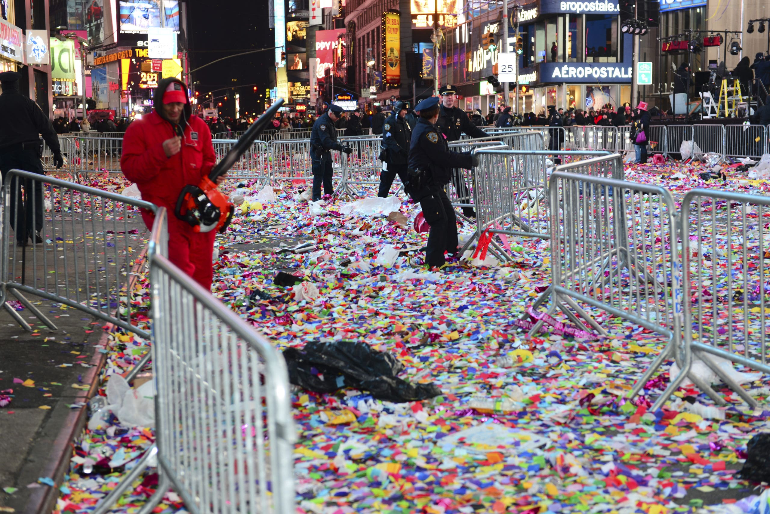 workers clean up confetti in times square