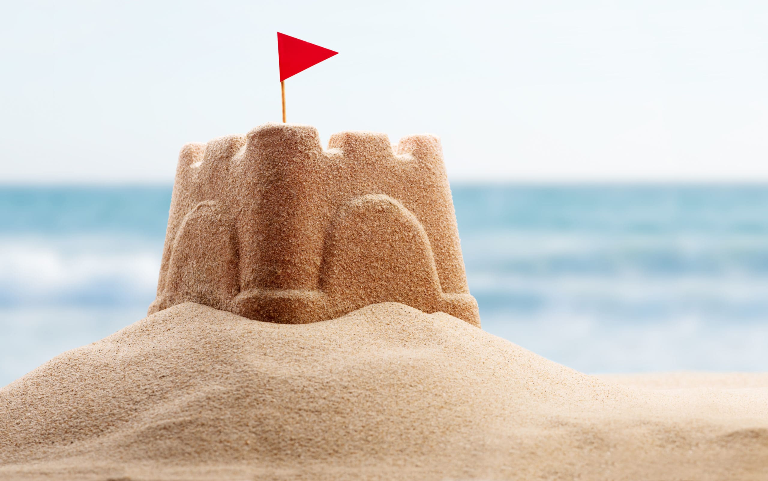 a sandcastle on a beach symbolizing effective change management