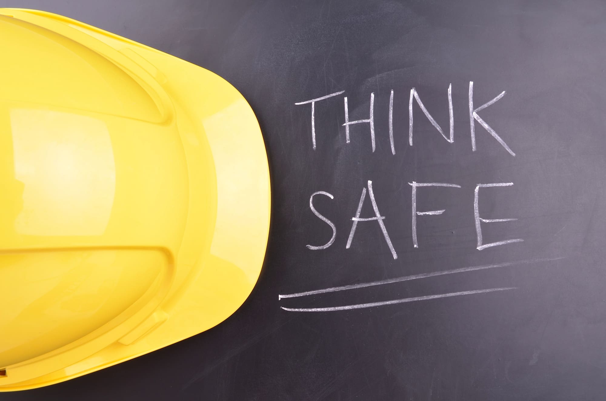 safety buy-in image of a yellow hardhat on a chalkboard that says "think safe"