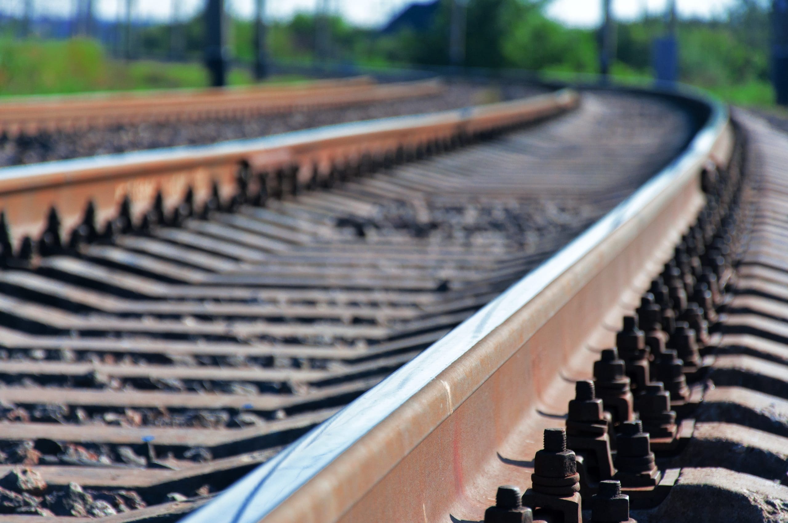 close up of railroad tracks turning, which rail fleets help maintain